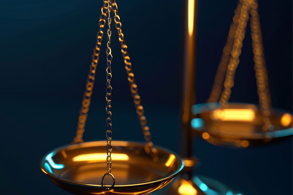 Close-up of a golden balance scale glowing against a dark background, symbolizing justice and fairness.