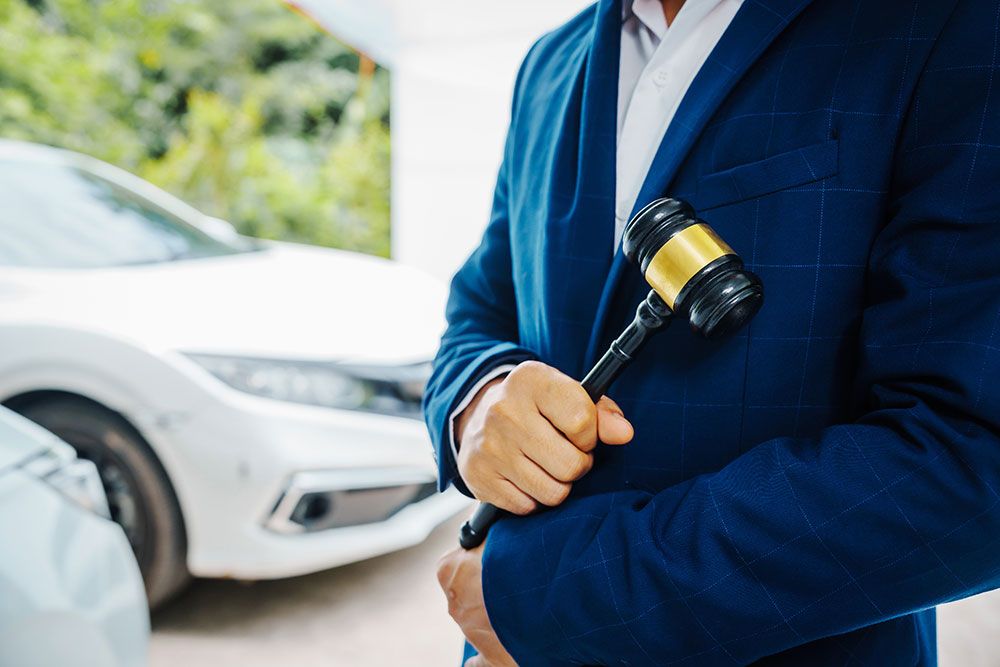 Lawyer holding a gavel with cars in the background, symbolizing DUI legal cases in Norfolk, Virginia. Understanding new DUI laws.