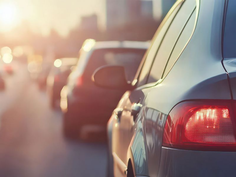 Traffic jam during sunset with cars lined up on a highway.