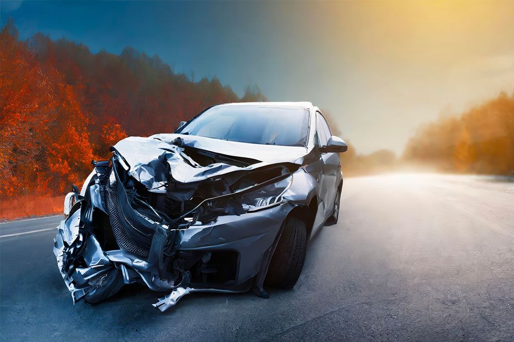 Crashed car on a rural road, symbolizing the consequences of reckless driving in Newport News, VA. Legal help for reckless driving cases.