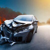 Crashed car on a rural road, symbolizing the consequences of reckless driving in Newport News, VA. Legal help for reckless driving cases.