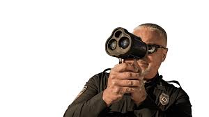 Police officer using a radar gun for speed monitoring against a white background.